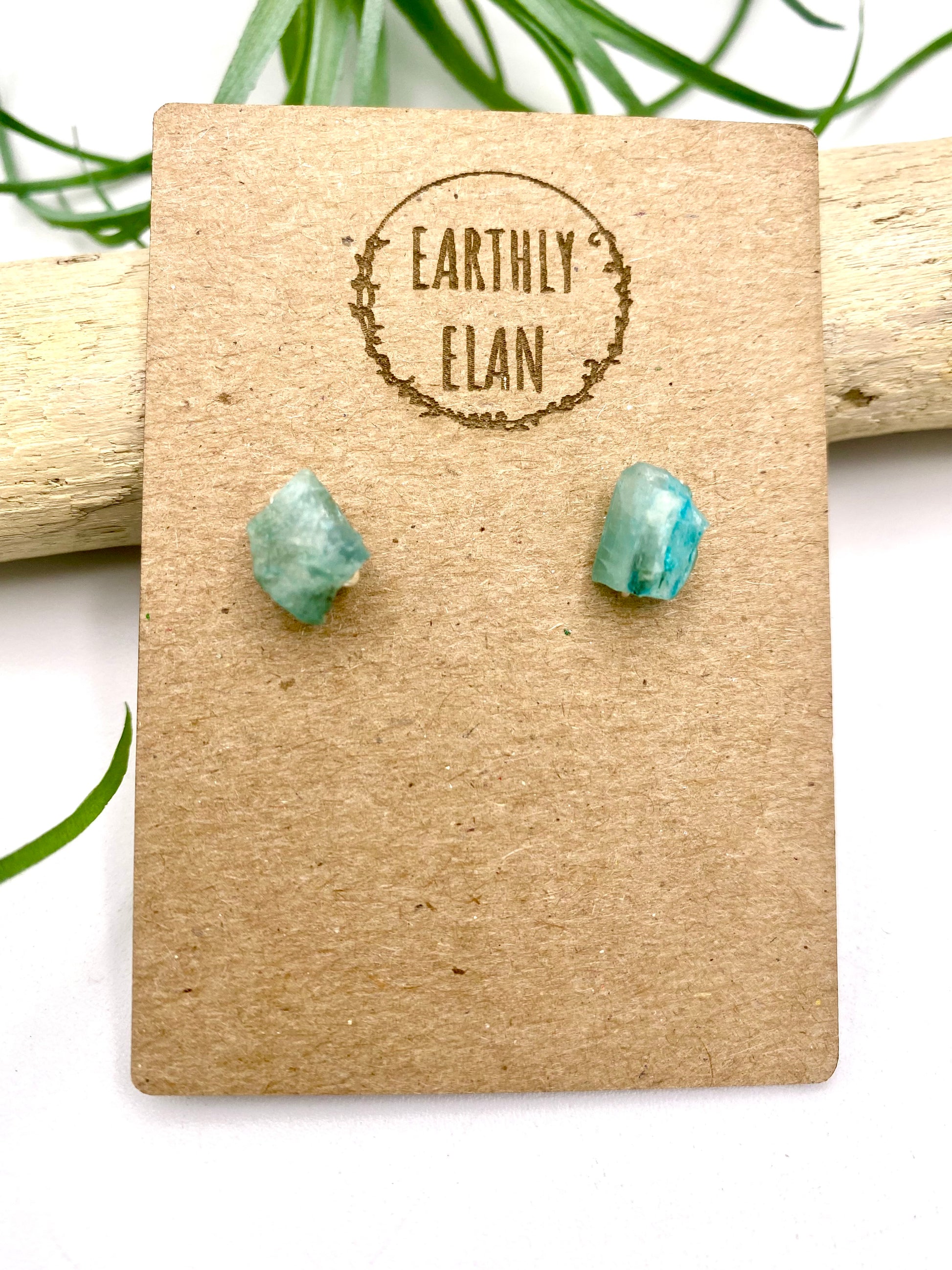 Pair of blue apatite gemstone stud earrings set in sterling silver on a jewelry card, showcasing a minimalist and elegant design.